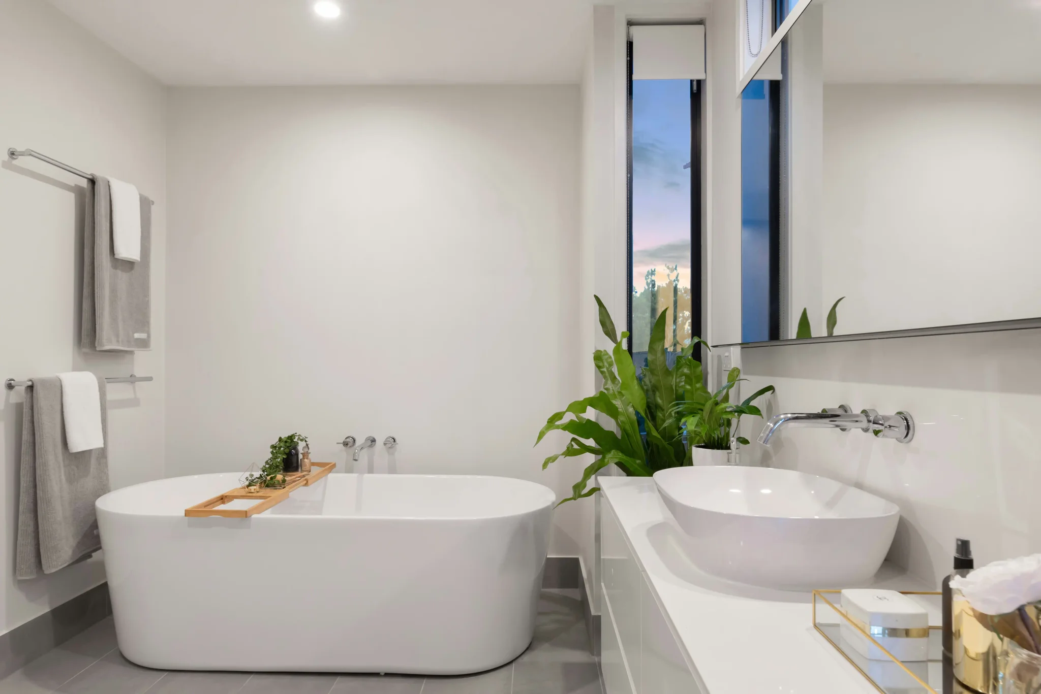 Bright bathroom with double vessel sinks and tile in a Northwest Denver home