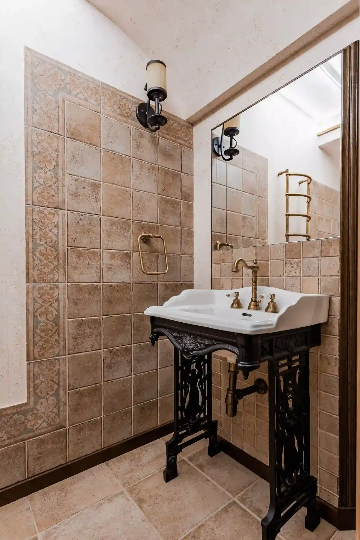 Vintage bathroom with ornate sink and terracotta tile in a Wheat Ridge bungalow